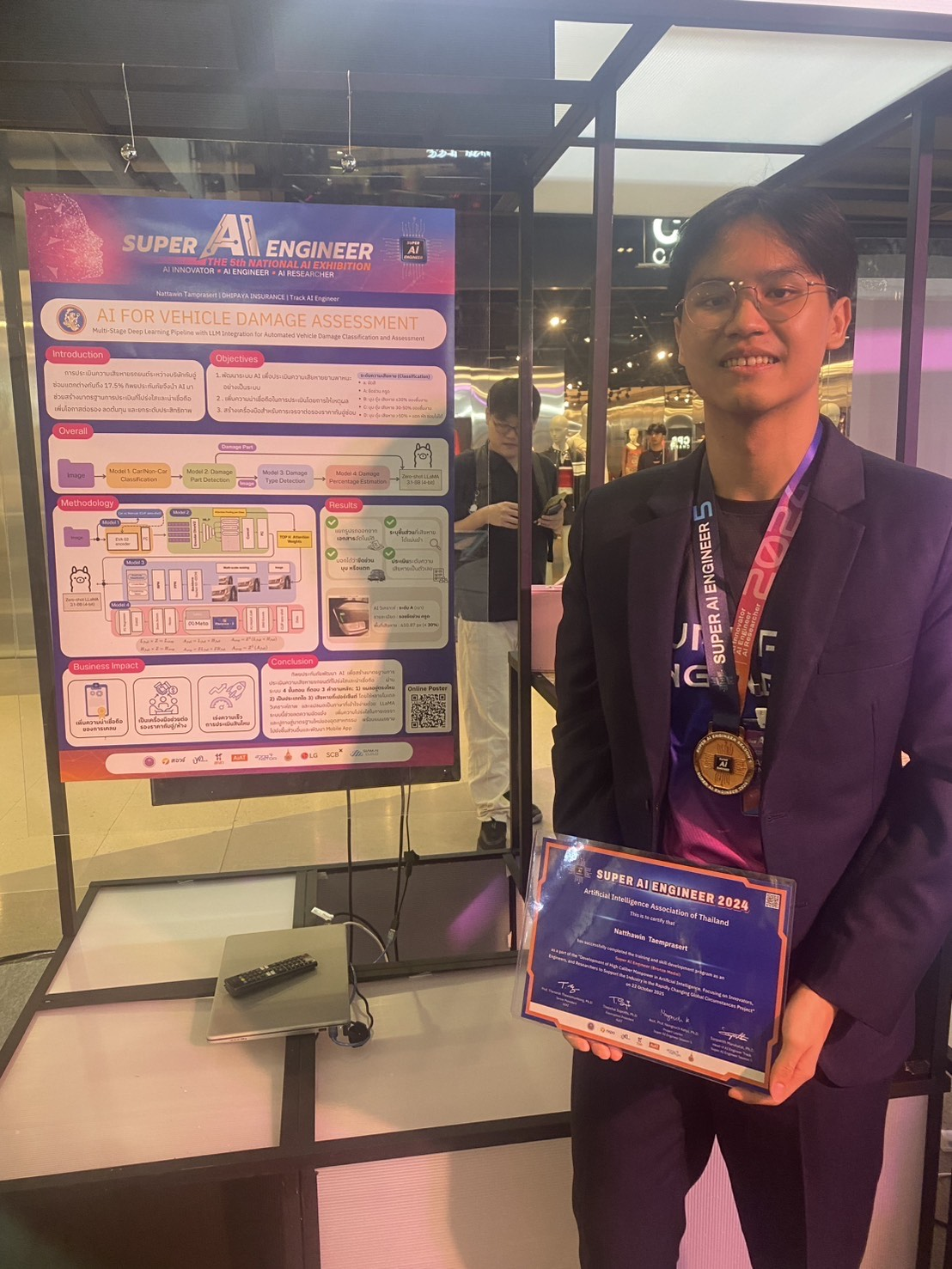 Natthawin with the Vehicle Damage Assessment poster and Bronze medal